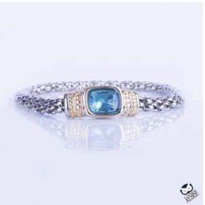 SILVER BRACELET WITH GOLD ACCENT AND BLUE STONE